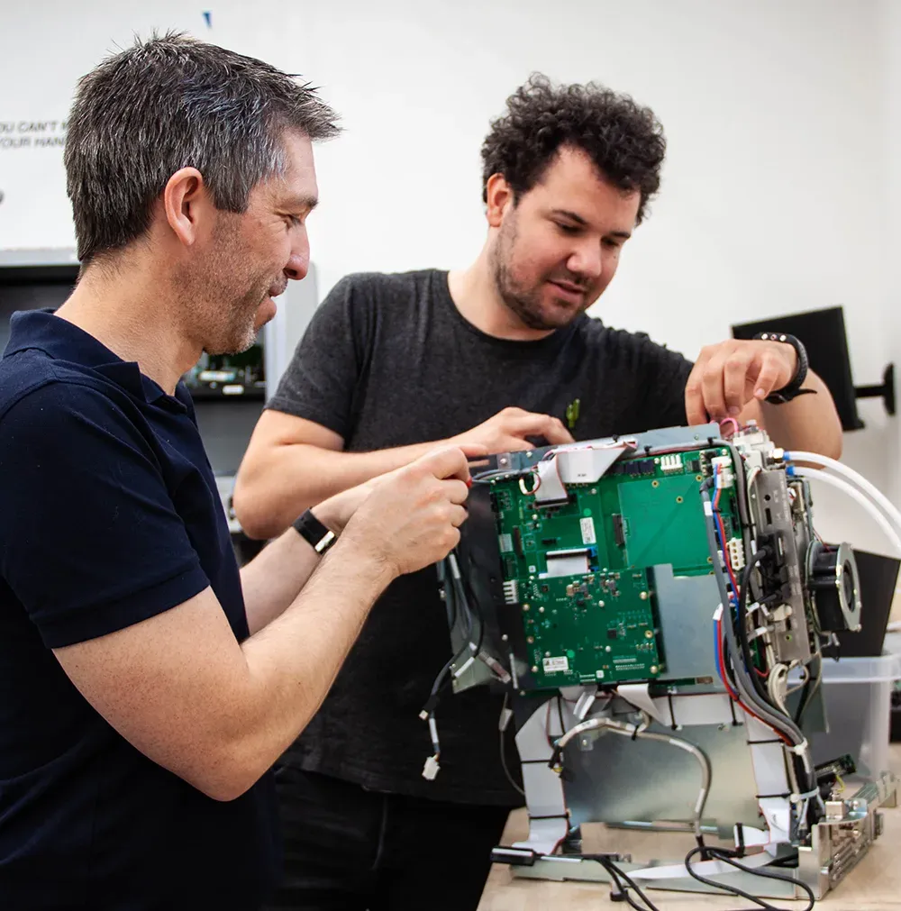 Two Service Lab engineers repairing a Phenom desktop SEM